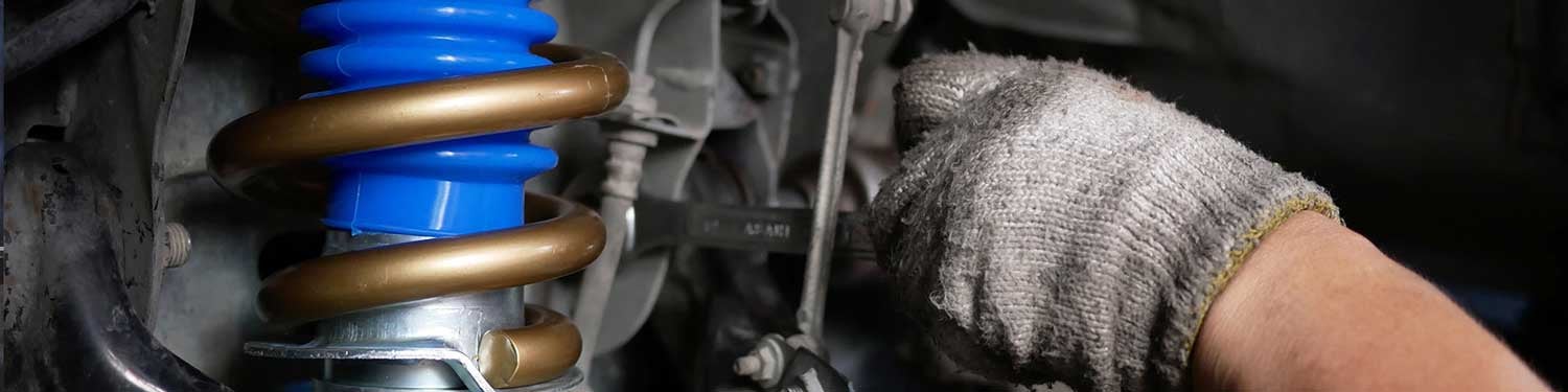 Mechanic repairing a vehicle's suspension